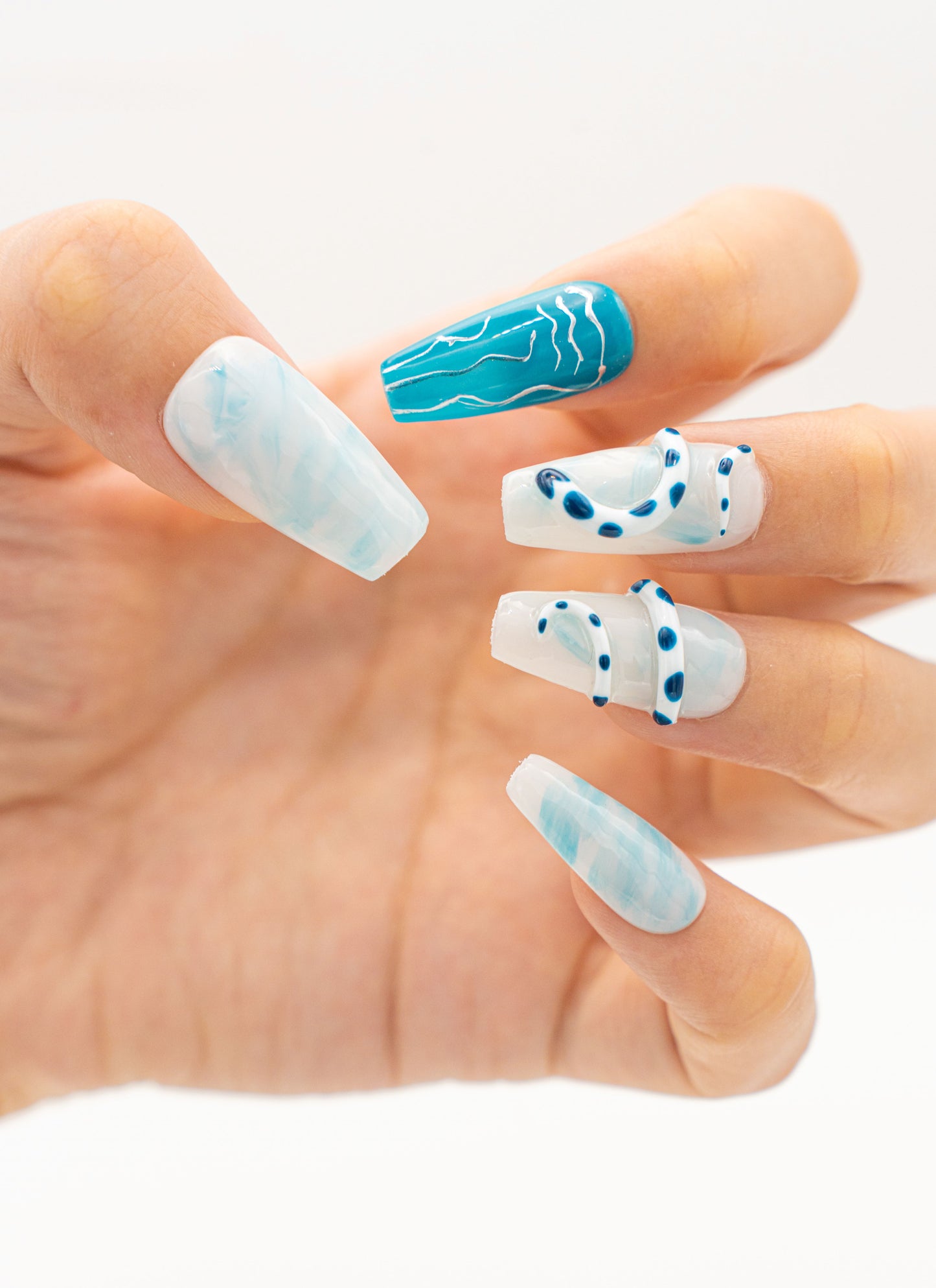 Close up image, Serpentine Charm: White Snake Print and Blue Jelly Medium Coffin Press On Nails